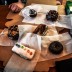 von links hinten nach rechts vorne: Diabolos Rex, Triple Chocolate Penetration,<br> Old Dirty Bastard, Bacon Maple Bar,<br> Gay Bar und Caris ominöser dritter Donut